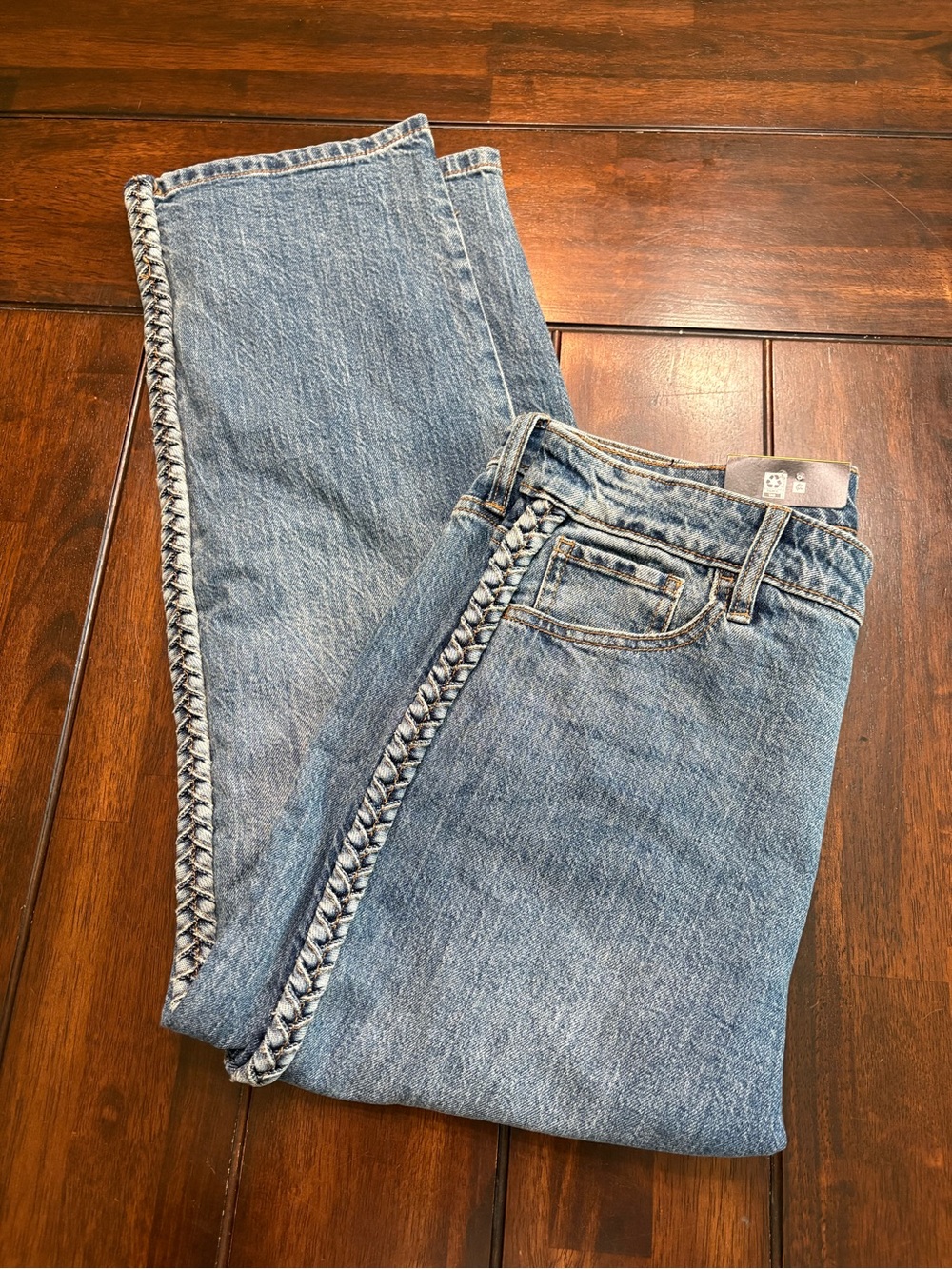 Express women’s blue denim ankle jeans with unique braided trim, size 8